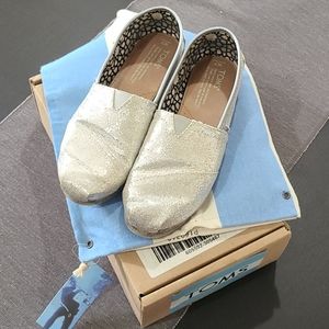 Tom's silver glitter slip on shoes.